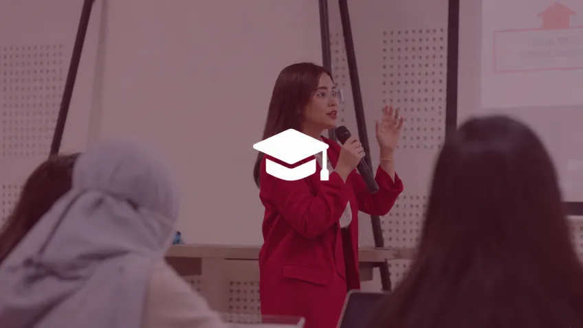 A lecturer speaking to students, with a graduation cap icon