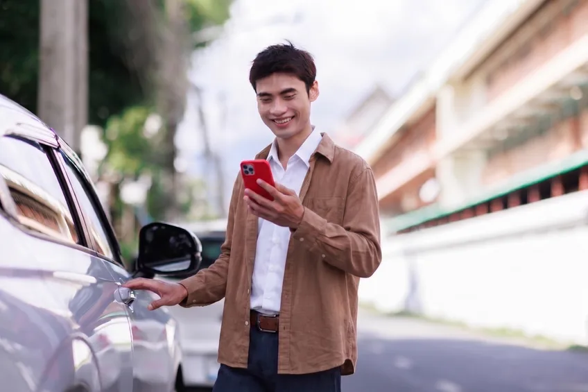 A man handing over vehicle keys at a dealership
